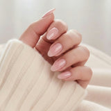Pinkie Pearl press-on naglar – delikat rosa pearl i mandelform mot creme stickad tröja